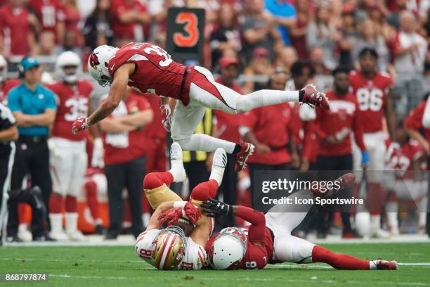 San Francisco 49ers wide receiver Trent Taylor is tackled by Arizona Cardinals cornerback Justin Bethel as Arizona Cardinals free safety Tyrann...