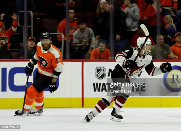 Clayton Keller of the Arizona Coyotes celebrates teammate Alex Goligoski's game winning goal as Jakub Voracek of the Philadelphia Flyers reacts in...