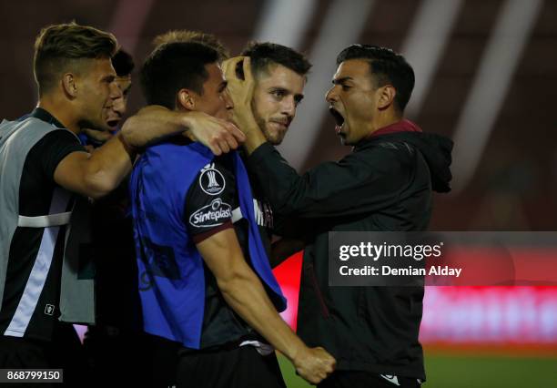 Alejandro Silva celebrates with teammates after scoring the fourth goal of his team during a second leg match between Lanus and River Plate as part...