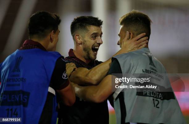 Alejandro Silva celebrates with teammates after scoring the fourth goal of his team during a second leg match between Lanus and River Plate as part...