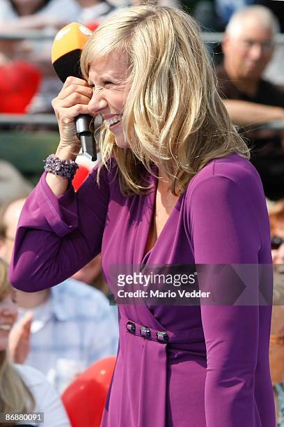 Host Andrea Kiewel laughs during the live broadcast of her TV Show 'ZDF Fernsehgarten' at the ZDF TV gardens on May 10, 2009 in Mainz, Germany.