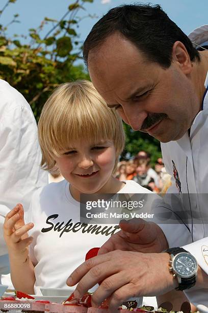 Chef Johann Lafer prepares a dessert with strawberries during the live broadcast of the TV Show 'ZDF Fernsehgarten' at the ZDF TV gardens on May 10,...