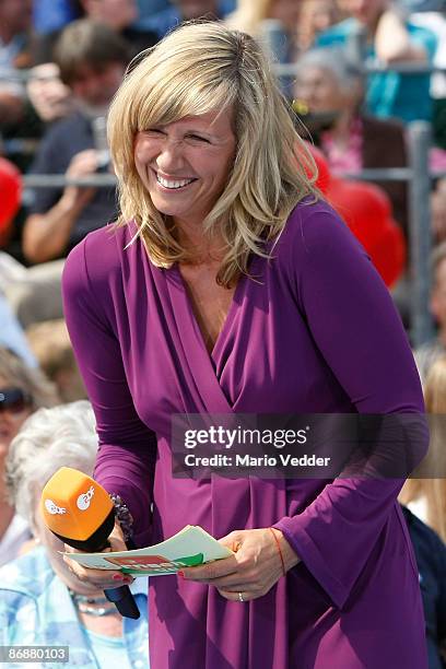 Host Andrea Kiewel laughs during the live broadcast of her TV Show 'ZDF Fernsehgarten' at the ZDF TV gardens on May 10, 2009 in Mainz, Germany.