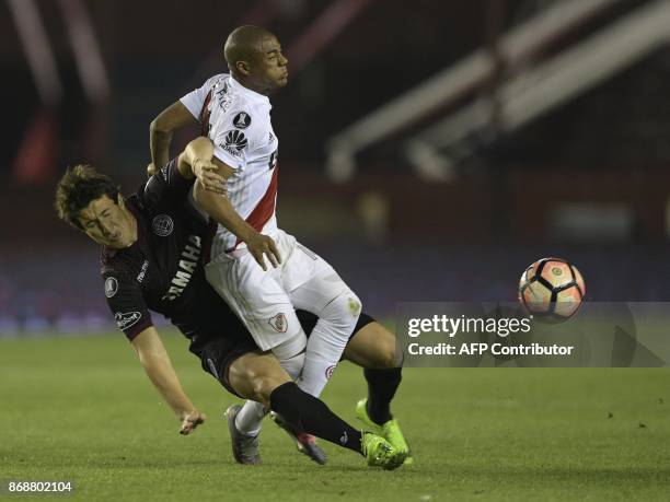 Argentina's Lanus midfielder Nicolas Aguirre vies for the ball with Argentina's River Plate midfielder Nicolas De La Cruz during their Copa...