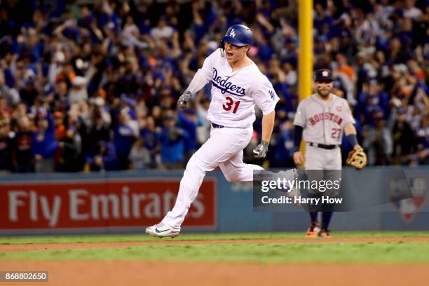 Joc Pederson of the Los Angeles Dodgers celebrates as he runs the bases after hitting a solo home run during the seventh inning against the Houston...