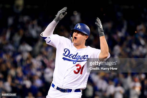 Joc Pederson of the Los Angeles Dodgers celebrates as he runs the bases after hitting a solo home run during the seventh inning against the Houston...