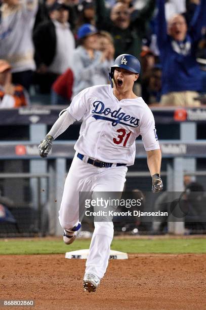 Joc Pederson of the Los Angeles Dodgers celebrates as he runs the bases after hitting a solo home run during the seventh inning against the Houston...