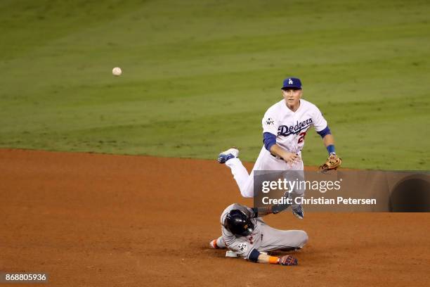 Josh Reddick of the Houston Astros is forced out at second base as Chase Utley of the Los Angeles Dodgers throws to first base during the seventh...