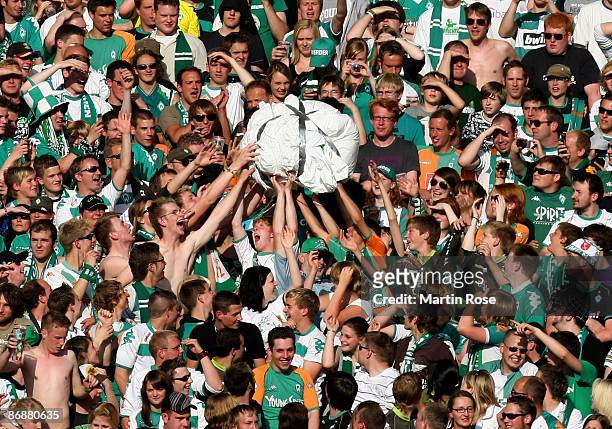 Supporters of Bremen hold a paper ball during the Bundesliga match between Werder Bremen and Hamburger SV at the Weser stadium on May 10, 2009 in...