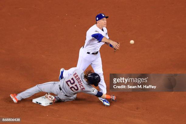 Josh Reddick of the Houston Astros is forced out at second base as Chase Utley of the Los Angeles Dodgers throws to first base during the seventh...
