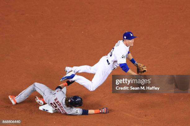 Josh Reddick of the Houston Astros is forced out at second base as Chase Utley of the Los Angeles Dodgers throws to first base during the seventh...