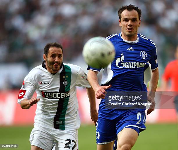 Oliver Neuville of Moenchengladbach and Heiko Westermann of Schalke watch the ball during the Bundesliga match between Borussia Moenchengladbach and...