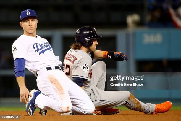 Josh Reddick of the Houston Astros is forced out at second base as Chase Utley of the Los Angeles Dodgers reacts after throwing to first base during...