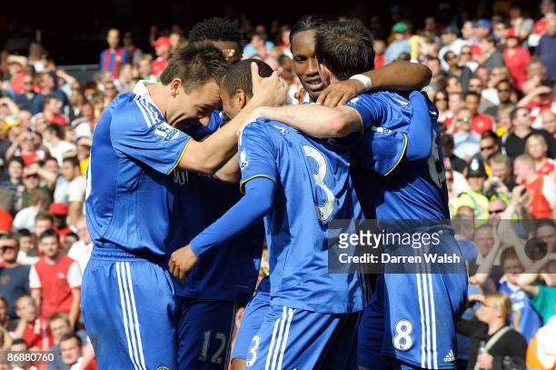 Ashley Cole of Chelsea is congratulated by team mates after his shot was deflected in by Kolo Toure of Arsenal for the third goal of the game during...