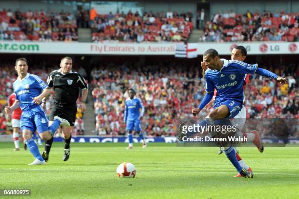 Ashley Cole of Chelsea sees his cross deflected in by Kolo Toure of Arsenal for the third goal of the game during the Barclays Premier League match...