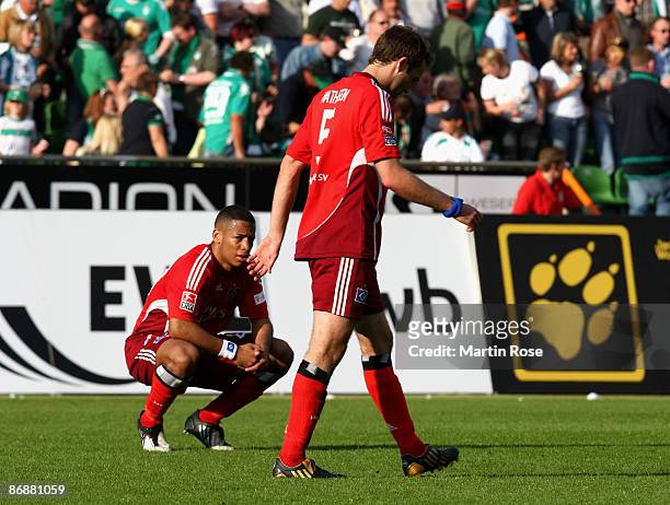 Dennis Aogo and Joris Mathijsen look dejected after the Bundesliga match between Werder Bremen and Hamburger SV at the Weser stadium on May 10, 2009...