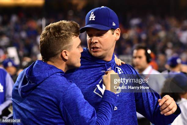 Enrique Hernandez of the Los Angeles Dodgers and Rich Hill react after defeating the Houston Astros 3-1 in game six of the 2017 World Series at...