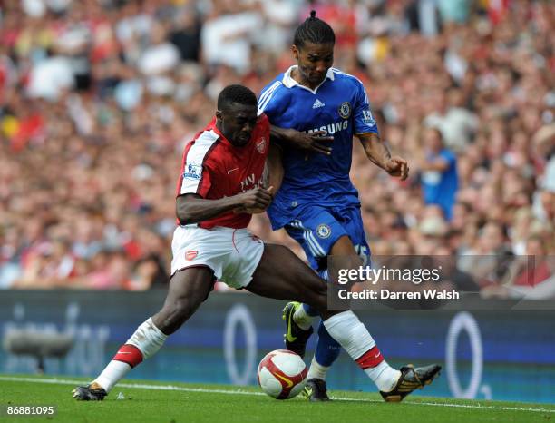 Kolo Toure of Arsenal pushes Florent Malouda of Chelsea off the ball during the Barclays Premier League match between Arsenal and Chelsea at the...