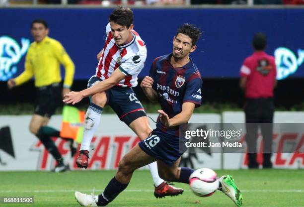 Carlos Fierro of Chivas fights for the ball with Juan Abarca of Atlante during the quarter final match between Chivas and Atlante as part of the Copa...