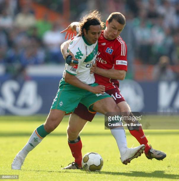 Claudio Pizarro of Bremen is challenged by Michael Gravgaard of Hamburg during the Bundesliga match between Werder Bremen and Hamburger SV at...