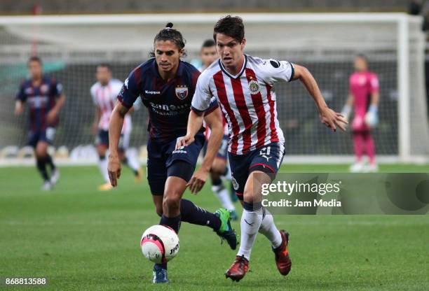 Irving Zurita of Atlante fights for the ball with Carlos Fierro of Chivas during the quarter final match between Chivas and Atlante as part of the...