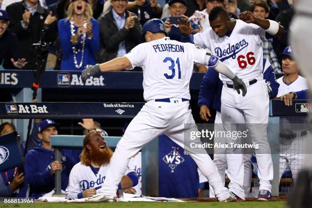 Joc Pederson of the Los Angeles Dodgers is greeted in the dugout after hitting a solo home run in the seventh inning during Game 6 of the 2017 World...