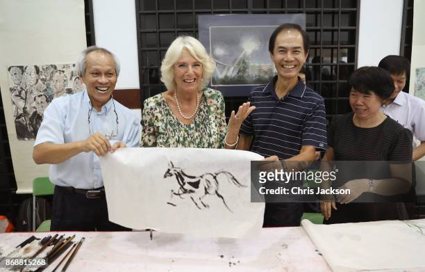 Camilla, Duchess of Cornwall paints a picture of a horse during her visit to the Tiong Bahru Community Centre on November 1, 2017 in Singapore....
