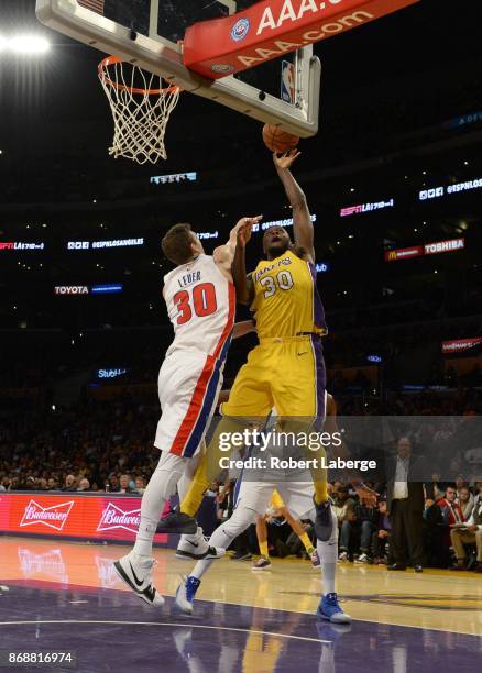 Julius Randle of the Los Angeles Lakers attempts a lay up against Jon Lauer of the Detroit Pistons on October 31, 2017 at STAPLES Center in Los...