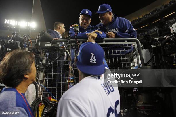 Yasiel Puig of the Los Angeles Dodgers shakes hands with Tommy Lasorda after the Dodgers defeated the Houston Astros in Game 6 of the 2017 World...