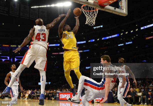 Julius Randle of the Los Angeles Lakers attempts a lay up against Anthony Tolliver and Jon Lauer of the Detroit Pistons on October 31, 2017 at...