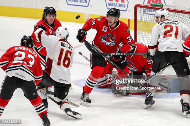 Rockford IceHogs center Luke Johnson , Cleveland Monsters center Miles Koules , Rockford IceHogs defenceman Carl Dahlstrom , and Cleveland Monsters...