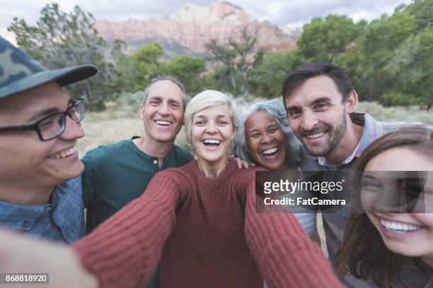 squeeze in for a group photo! - baby boomer stock pictures, royalty-free photos & images