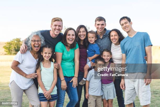 family reunion! - toothy smile family outdoors stock pictures, royalty-free photos & images