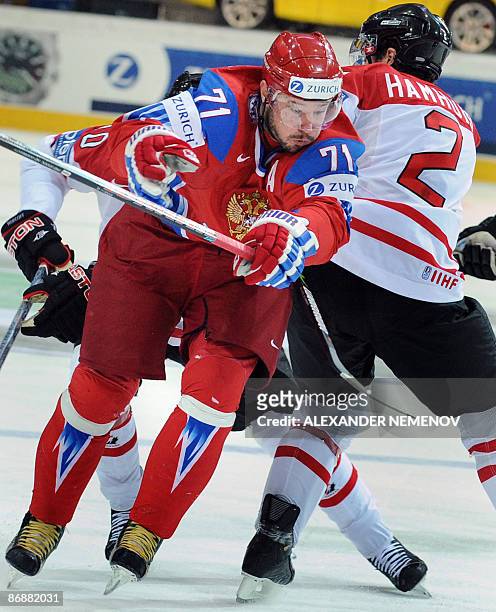 Russia's Ilya Kovalchuk of the Atlanta Thrashers tries to pass Canadian Dan Hamhuis of the Nashville Predators during their final game in the IIHF...