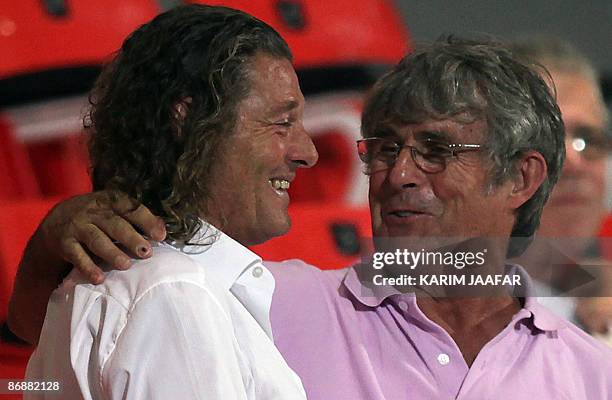 Newly-appointed coach of Iraq's national football team, Bora Milutinovic , speaks with Qatar's national football team French coach Bruno Metsu as...