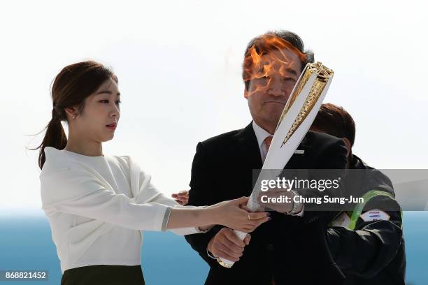 South Korean prime minister Lee Nak-yon and 2010 Vancouver Olympic figure skating champion Kim Yu-Na hold the PyeongChang 2018 Winter Olympics torch...