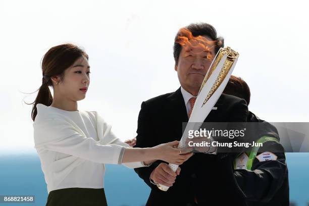South Korean prime minister Lee Nak-yon and 2010 Vancouver Olympic figure skating champion Kim Yu-Na hold the PyeongChang 2018 Winter Olympics torch...