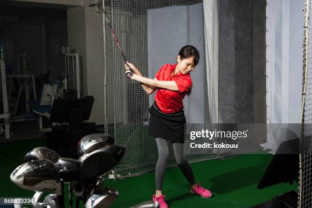 women practicing at golf studios. - golf simulator stock pictures, royalty-free photos & images