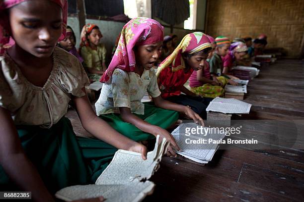 Burmese Rohingya madrassa students read the Koran during religious class on May 4, 2009 in Sittwe, Arakan state, Myanmar . The Rohingya Muslim...