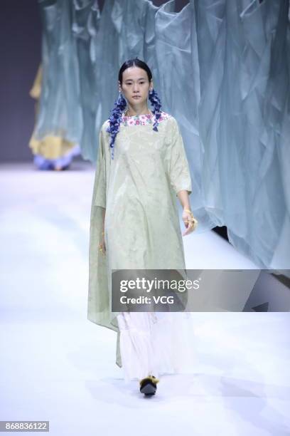 Model showcases designs on the runway at the A Life On The Left collection by designer Lin Qi during the Mercedes-Benz China Fashion Week...