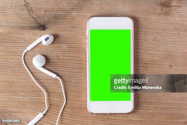 green screen handheld smartphone - chroma key stock pictures, royalty-free photos & images