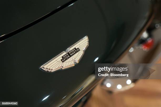 An Aston Martin Lagonda Ltd. Badge is seen on a DB6 Mk2 Volante automobile at a showroom in Tokyo, Japan, on Wednesday, Nov 1., 2017. The luxury...