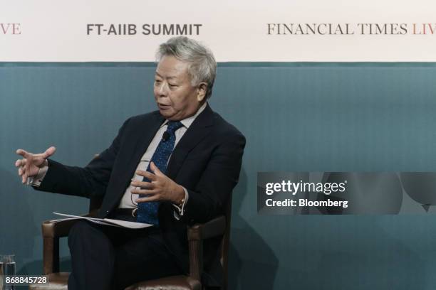 Jin Liqun, president of the Asian Infrastructure Investment Bank , gestures while speaking during the FT-AIIB Summit in Hong Kong, China, on...