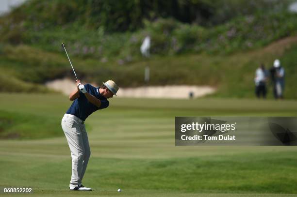 Tapio Pulkkanen of Finland hits an approach shot on the 3rd hole during day one of the NBO Golf Classic Grand Final at Al Mouj Golf on November 1,...