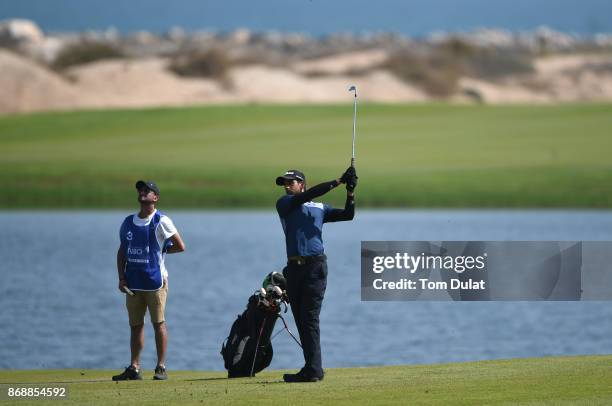 Aaron Rai of England hits an approach shot on the 4th hole during day one of the NBO Golf Classic Grand Final at Al Mouj Golf on November 1, 2017 in...