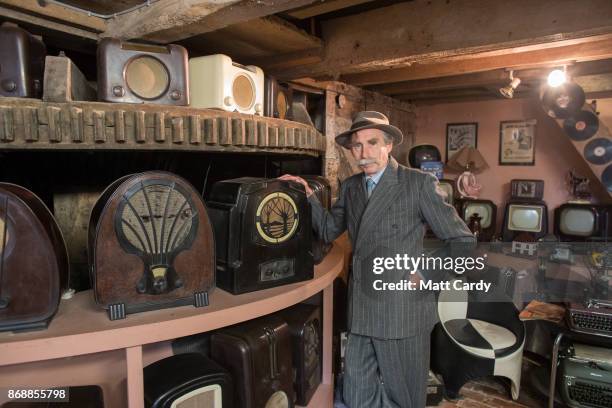 Patrick Cook, poses for a photograph with a Bakelite radio, at the Bakelite Museum, which is a vast collection of Bakelite objects and vintage...