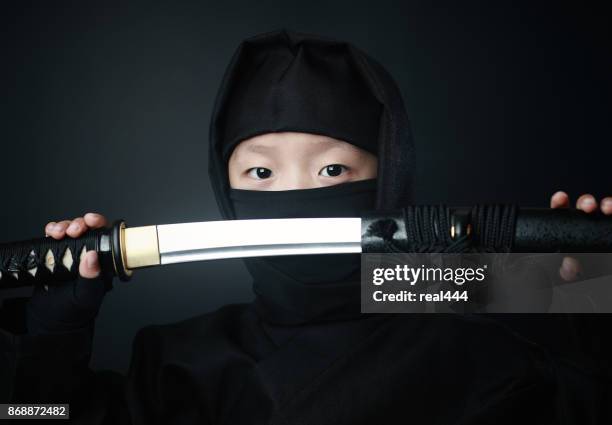 boy in ninja costume - ninja weapon stock pictures, royalty-free photos & images