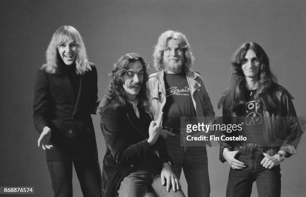 Canadian progressive rock group Rush, 1978. From left to right: guitarist Alex Lifeson, drummer Neil Peart, record producer Terry Brown, and...