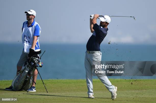 Nick Cullen of Australia hits an approach shot on the 18th hole during day one of the NBO Golf Classic Grand Final at Al Mouj Golf on November 1,...