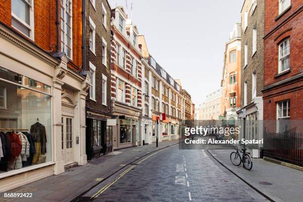 street with shops and cafes in marylbone, london, uk - façade de magasin photos et images de collection